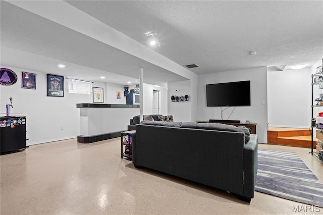 living area featuring a textured ceiling, recessed lighting, and bar