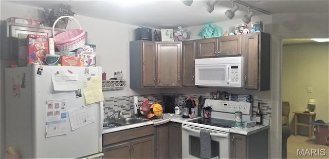 731 Old Moscow Mills Rd, Troy, MO 63379 - kitchen with white appliances, light countertops, a sink, track lighting, and backsplash