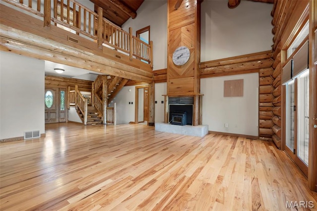 3333 State Highway 177, Cape Girardeau, MO 63701 - unfurnished living room with high vaulted ceiling, stairs, wood finished floors, a fireplace with raised hearth, and beam ceiling