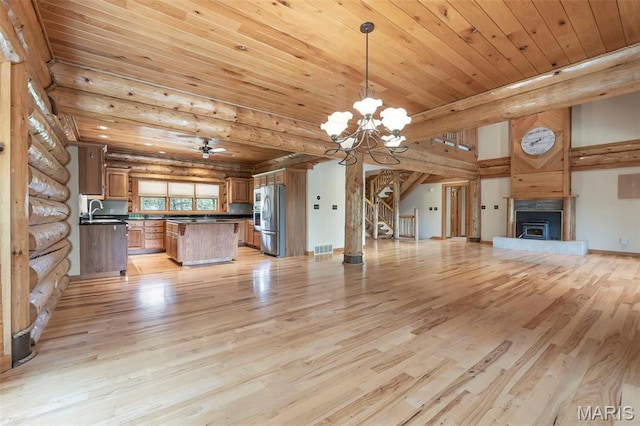 3333 State Highway 177, Cape Girardeau, MO 63701 - unfurnished living room with light wood-style flooring, a chandelier, wood ceiling, a fireplace with raised hearth, and stairs