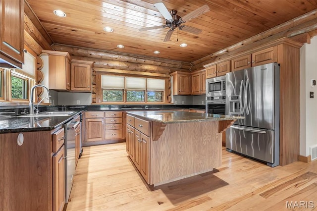 3333 State Highway 177, Cape Girardeau, MO 63701 - kitchen with appliances with stainless steel finishes, wooden ceiling, a sink, light wood-style flooring, and rustic walls