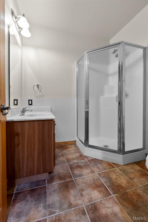 3333 State Highway 177, Cape Girardeau, MO 63701 - full bathroom featuring vanity, a shower stall, baseboards, and tile patterned floors