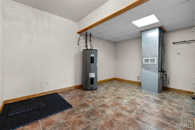 3333 State Highway 177, Cape Girardeau, MO 63701 - finished basement featuring electric water heater, a paneled ceiling, baseboards, and tile patterned flooring