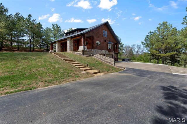 3333 State Highway 177, Cape Girardeau, MO 63701 - view of property exterior featuring asphalt driveway, a garage, a yard, and stone siding