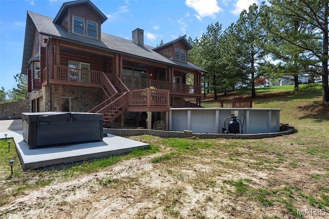 3333 State Highway 177, Cape Girardeau, MO 63701 - back of house featuring a hot tub, stone siding, a chimney, stairs, and a pool