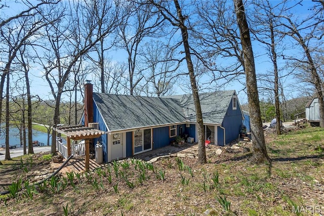 276 Cheyenne Ln, Perryville, MO 63775 - view of front of home with a chimney, roof with shingles, and a water view