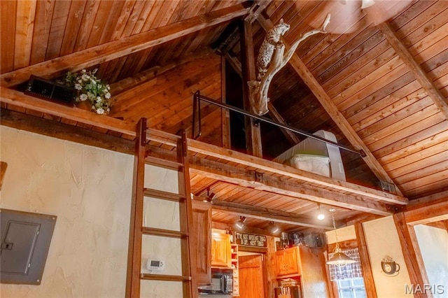 detailed view of electric panel, wooden ceiling, beam ceiling, black microwave, and wooden walls