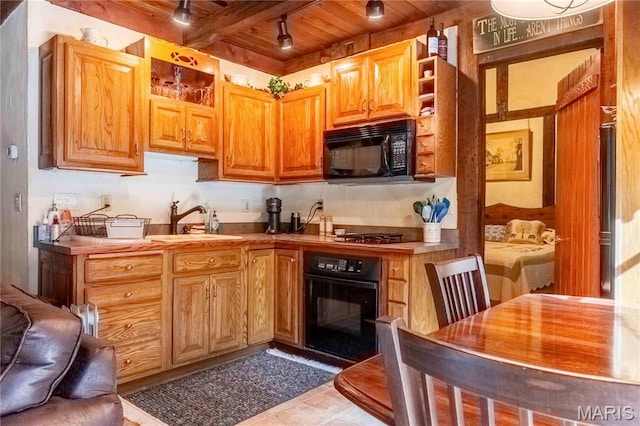 kitchen featuring black appliances, a sink, wooden ceiling, open shelves, and track lighting