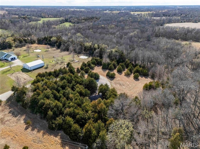 aerial view of property and surrounding area with a forest