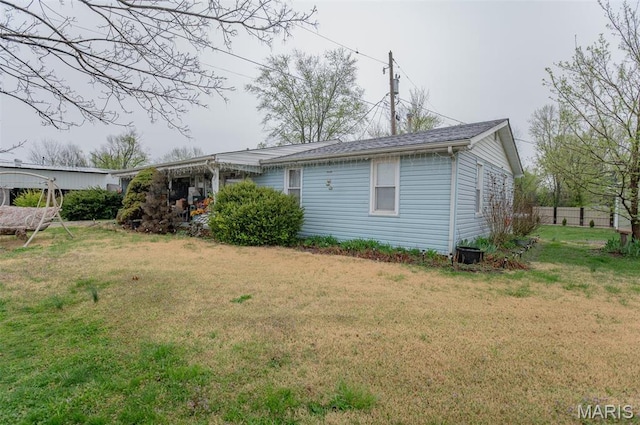 rear view of house with a lawn