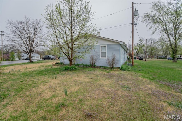 view of side of home with a lawn