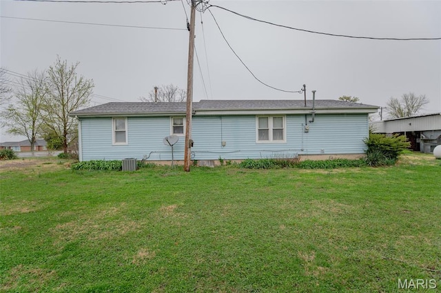 back of property with a lawn and central AC unit