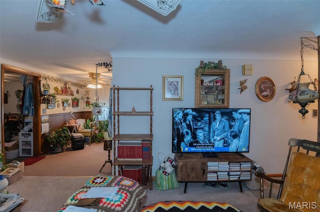 carpeted living area featuring a ceiling fan
