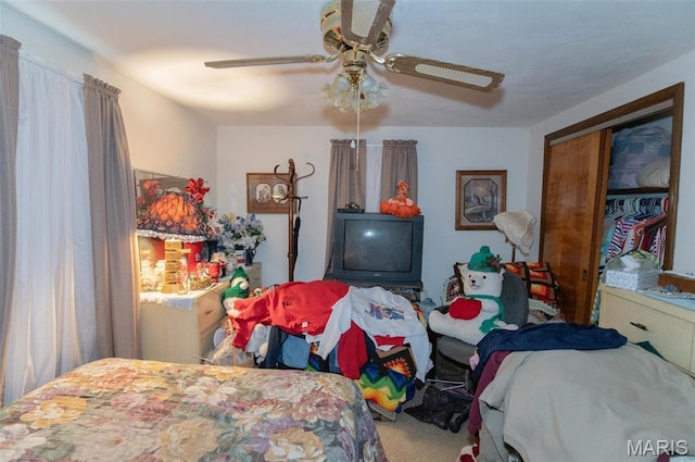 carpeted bedroom with a ceiling fan and a closet