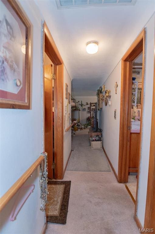 hall with light colored carpet