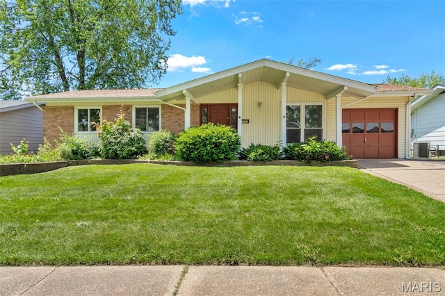 1366 Springhurst Dr, Florissant, MO 63031 - view of front of property featuring a garage, a front lawn, concrete driveway, and brick siding