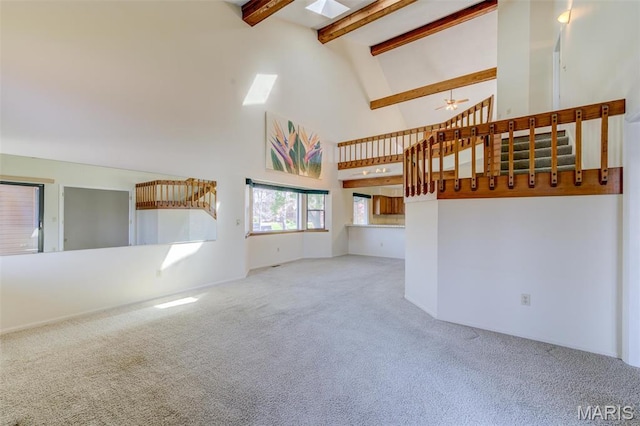 228 Hemingway Ln Unit F, Weldon Spring, MO 63304 - unfurnished living room featuring carpet floors, stairway, high vaulted ceiling, beamed ceiling, and a ceiling fan
