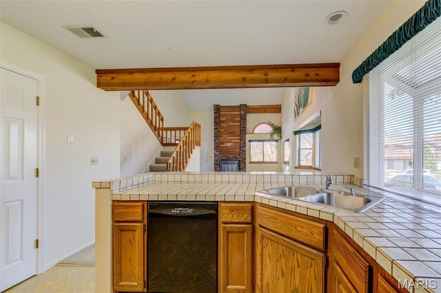228 Hemingway Ln Unit F, Weldon Spring, MO 63304 - kitchen featuring black dishwasher, a sink, open floor plan, beam ceiling, and tile countertops