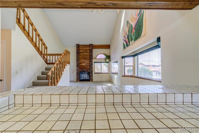 228 Hemingway Ln Unit F, Weldon Spring, MO 63304 - unfurnished living room featuring high vaulted ceiling, a fireplace, and stairs