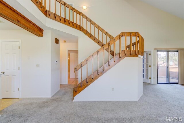 228 Hemingway Ln Unit F, Weldon Spring, MO 63304 - staircase with a high ceiling, carpet floors, and baseboards