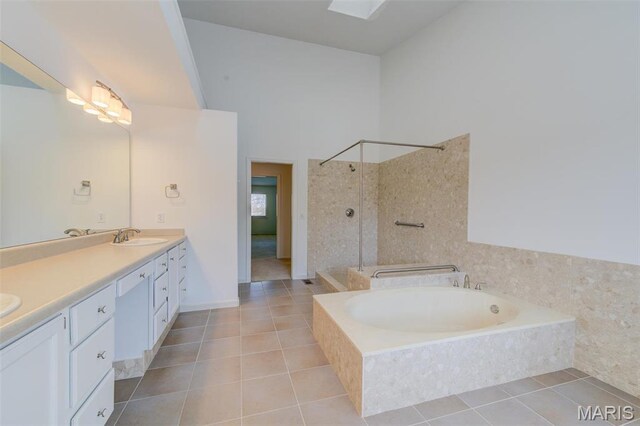 228 Hemingway Ln Unit F, Weldon Spring, MO 63304 - full bath featuring tile patterned flooring, tiled shower, double vanity, a garden tub, and a towering ceiling