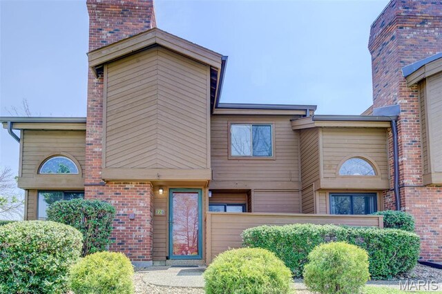 228 Hemingway Ln Unit F, Weldon Spring, MO 63304 - view of front of property with a chimney