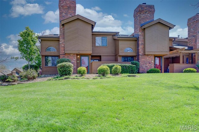 228 Hemingway Ln Unit F, Weldon Spring, MO 63304 - view of front of house featuring a front yard and a chimney