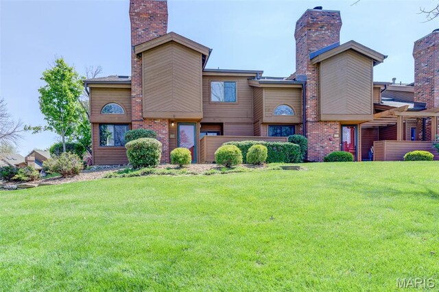 228 Hemingway Ln Unit F, Weldon Spring, MO 63304 - view of front of house with a front lawn and a chimney