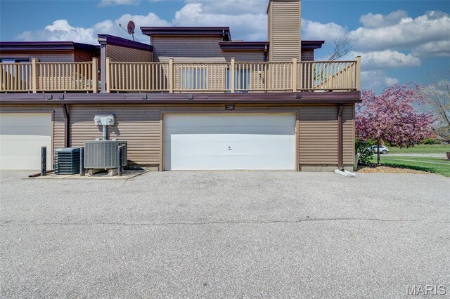 228 Hemingway Ln Unit F, Weldon Spring, MO 63304 - garage featuring central AC unit and asphalt driveway