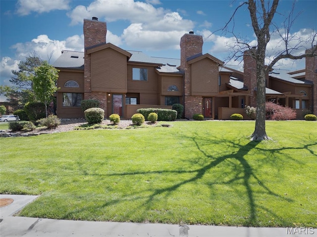 228 Hemingway Ln Unit F, Weldon Spring, MO 63304 - exterior space with a chimney, a lawn, and brick siding