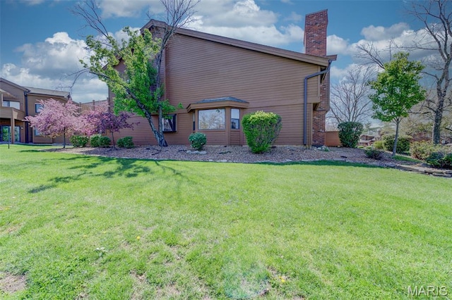 228 Hemingway Ln Unit F, Weldon Spring, MO 63304 - view of side of property with a chimney and a lawn