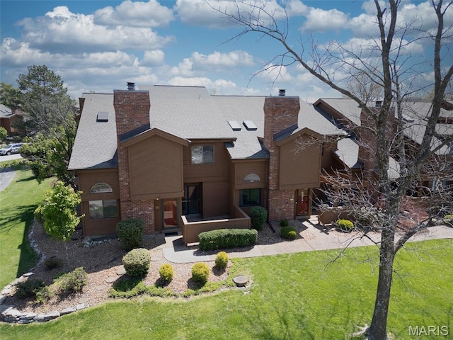 228 Hemingway Ln Unit F, Weldon Spring, MO 63304 - view of front facade with a chimney, a front yard, and brick siding