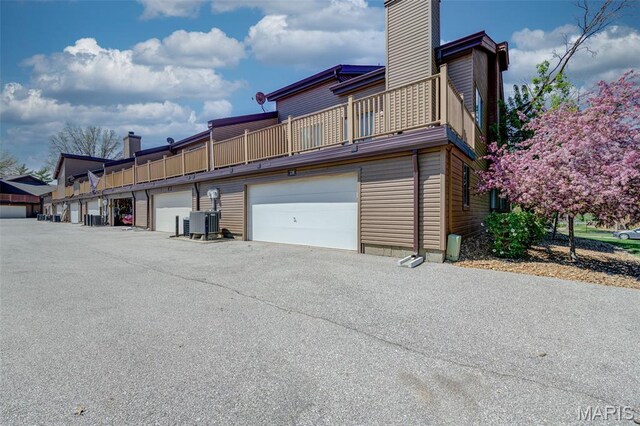 228 Hemingway Ln Unit F, Weldon Spring, MO 63304 - view of property exterior with a chimney and a balcony