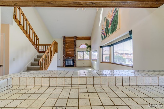 228 Hemingway Ln Unit F, Weldon Spring, MO 63304 - entryway featuring high vaulted ceiling, a fireplace, and stairway