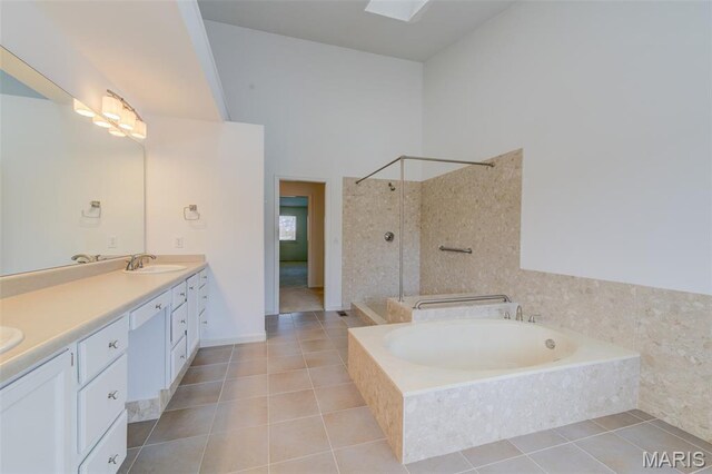 228 Hemingway Ln Unit F, Weldon Spring, MO 63304 - full bath with double vanity, tiled shower, tile patterned floors, a garden tub, and a towering ceiling