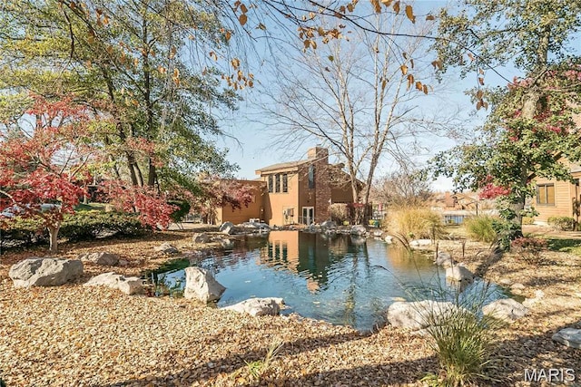 228 Hemingway Ln Unit F, Weldon Spring, MO 63304 - view of pool featuring a small pond