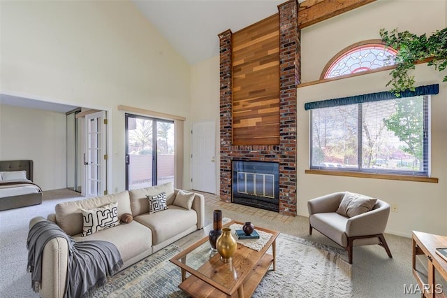 228 Hemingway Ln Unit F, Weldon Spring, MO 63304 - living room with high vaulted ceiling, carpet floors, healthy amount of natural light, and a brick fireplace