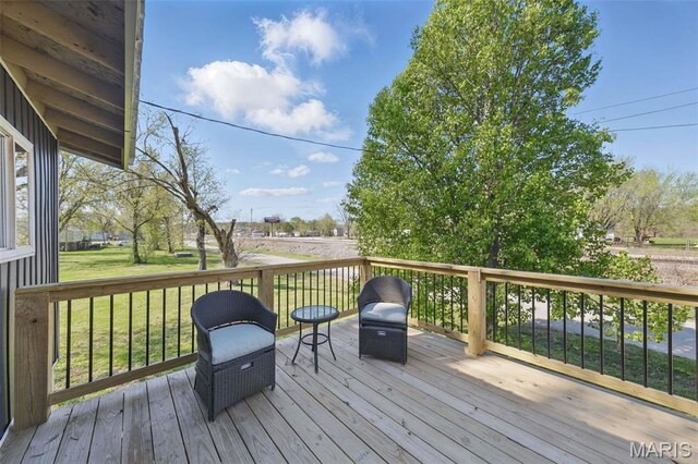 wooden terrace with a yard