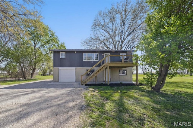 908 Railroad Ave, Foley, MO 63347 - view of front of property with stairs, gravel driveway, a front yard, a deck, and a garage