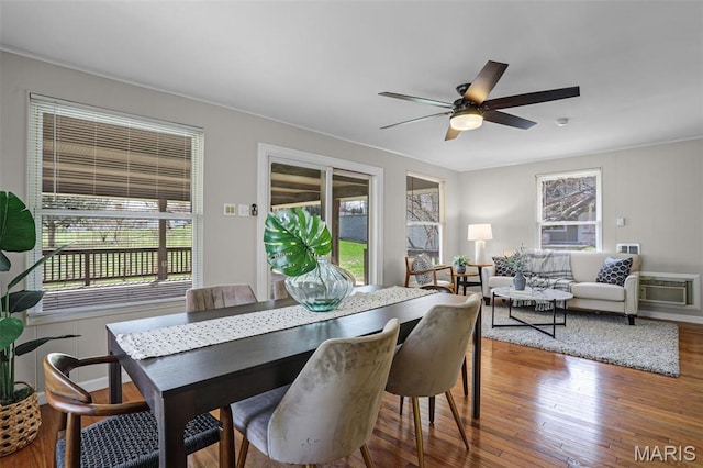 dining area featuring plenty of natural light, wood finished floors, and a ceiling fan