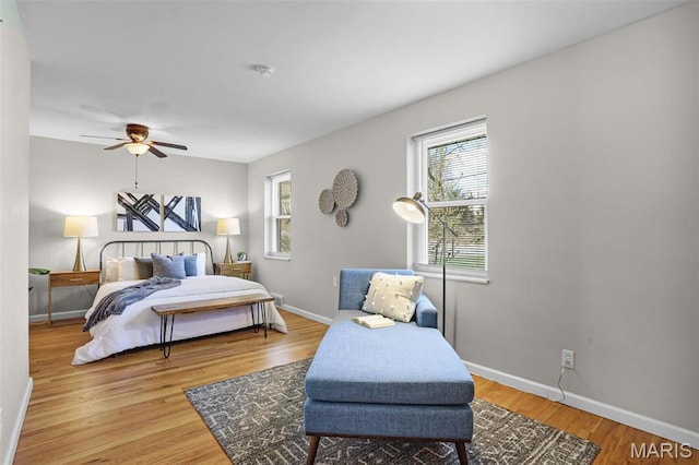 bedroom featuring baseboards and wood finished floors