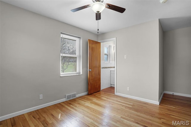 unfurnished bedroom featuring baseboards, light wood-type flooring, and ceiling fan