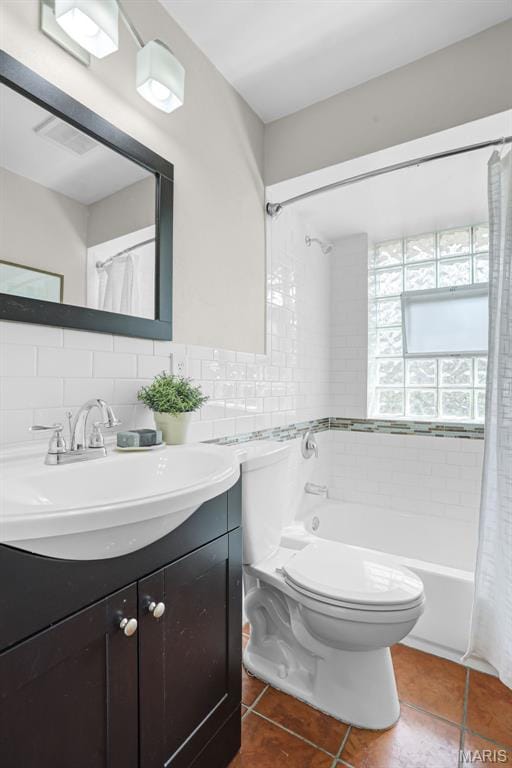 full bathroom with toilet, tile patterned flooring, vanity, shower / bath combination with curtain, and tile walls