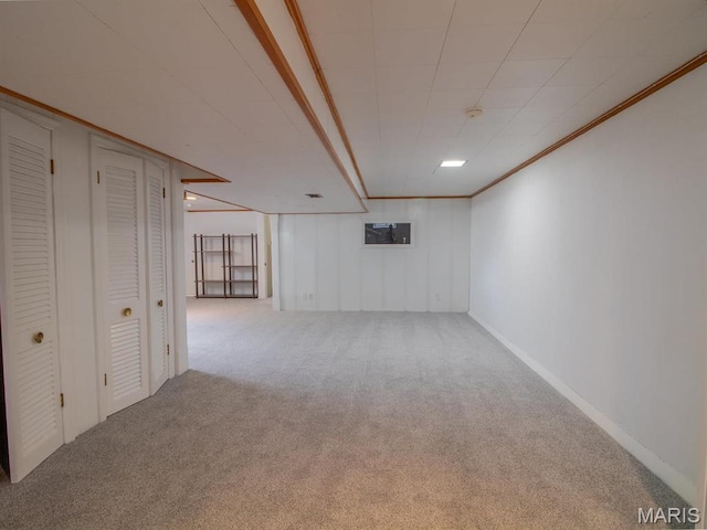 finished below grade area with carpet flooring and ornamental molding