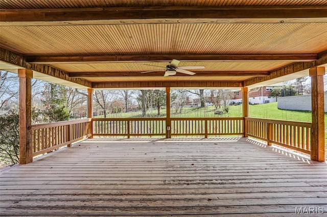 wooden deck with a ceiling fan and a lawn