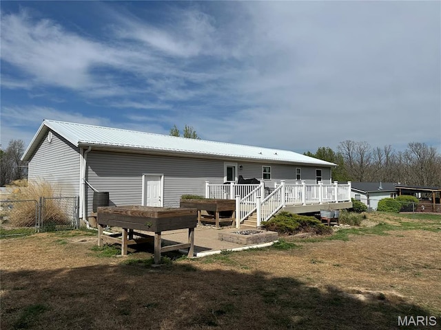404 Crystal Ln, Rosebud, MO 63091 - rear view of house with a deck and metal roof