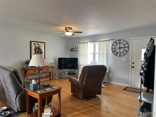 404 Crystal Ln, Rosebud, MO 63091 - living area featuring ceiling fan, baseboards, and light wood-type flooring