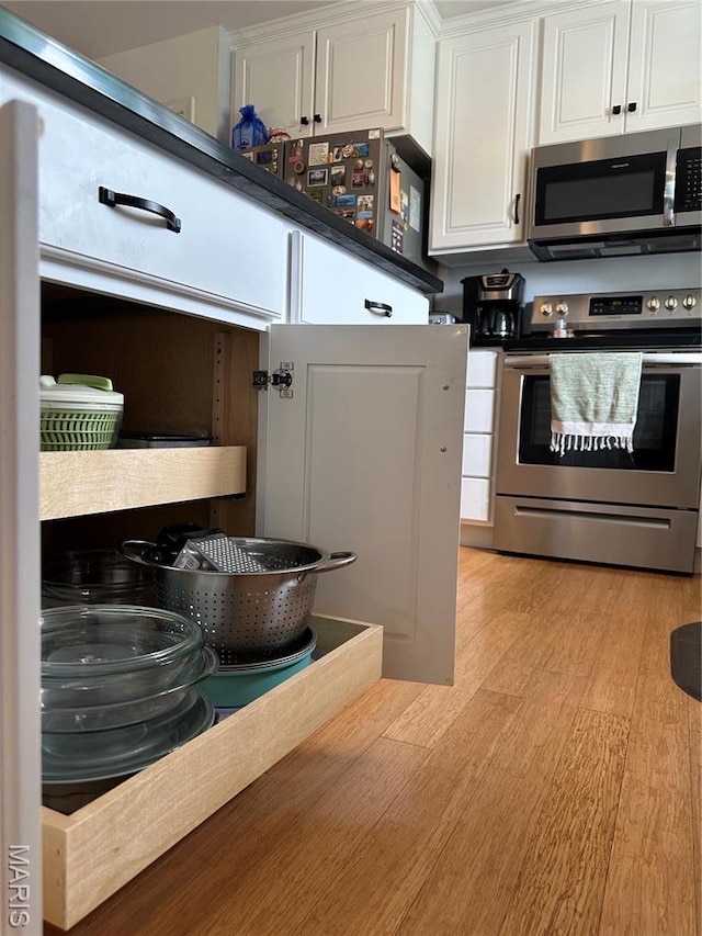 404 Crystal Ln, Rosebud, MO 63091 - kitchen with stainless steel appliances, white cabinetry, and light wood-style flooring