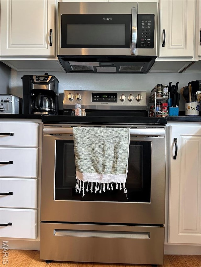 404 Crystal Ln, Rosebud, MO 63091 - kitchen with appliances with stainless steel finishes and white cabinetry