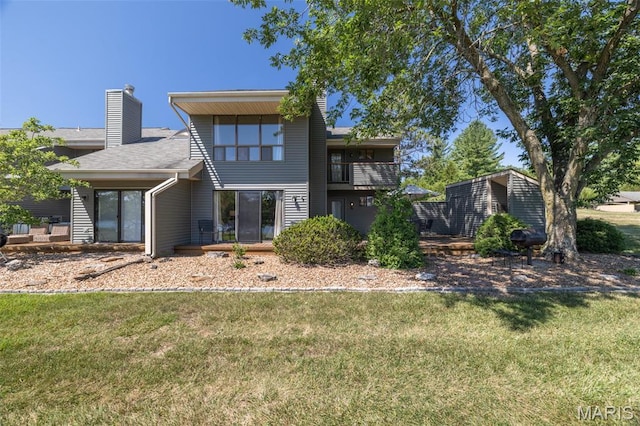 31 N Lionshead Dr, Innsbrook, MO 63390 - rear view of property featuring a yard, a chimney, and a balcony